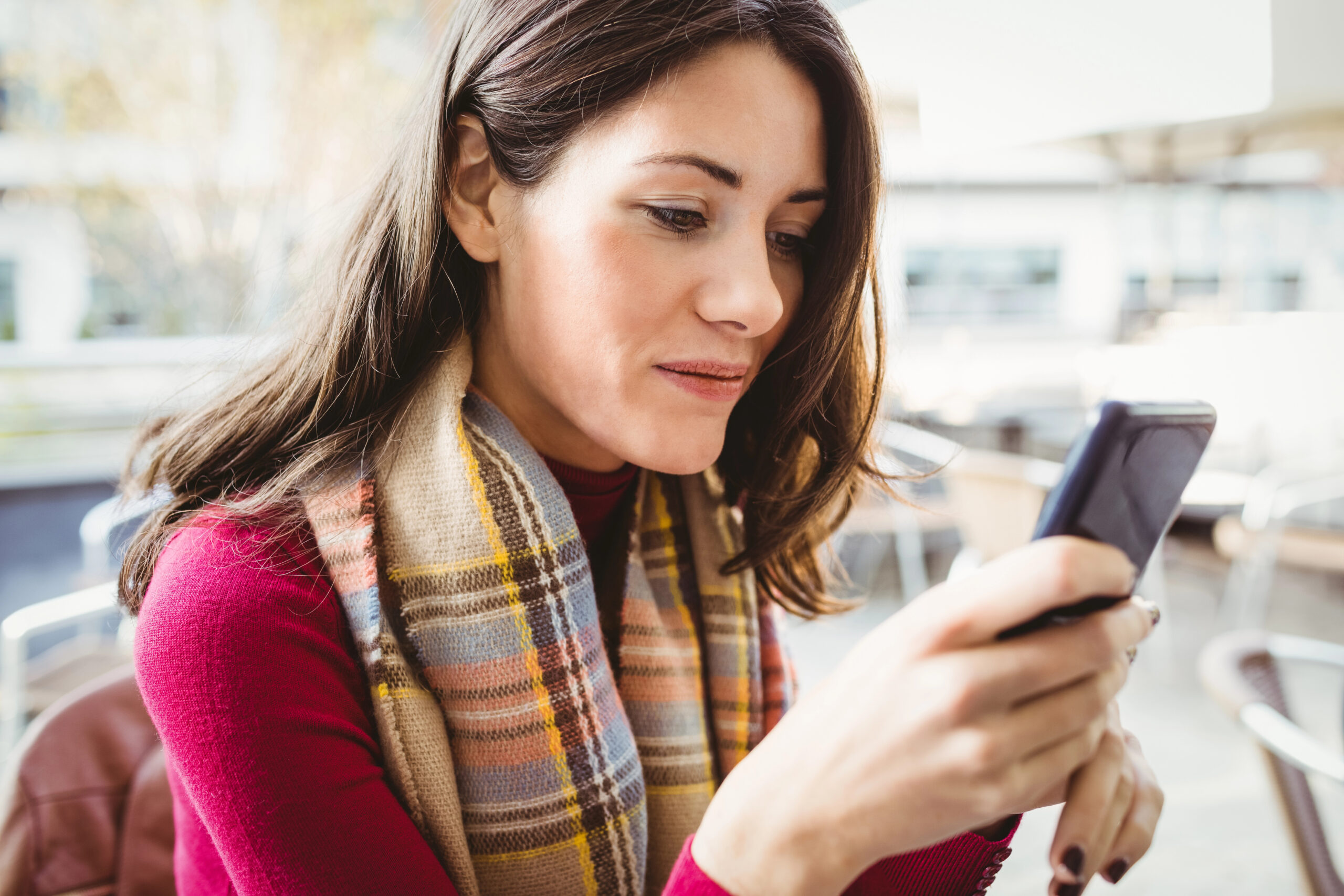 Business owner reviewing her marketing message clarity on her phone