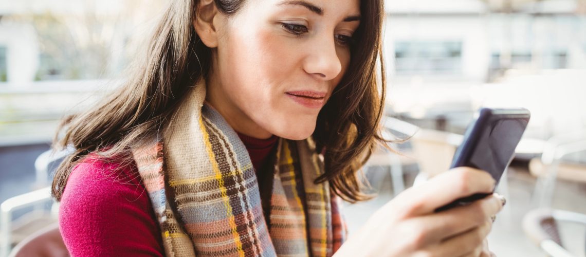 Business owner reviewing her marketing message clarity on her phone