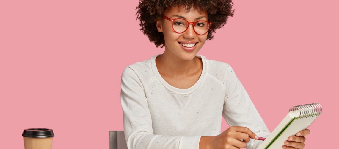 horizontal-shot-of-cheerful-afro-african-painter-wears-red-rim-spectacles-makes-sketches-in-spiral.jpg